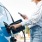 woman filling up gas while texting
