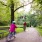 father and daughter bike along park path