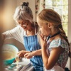 grandmother and granddaughter bake together